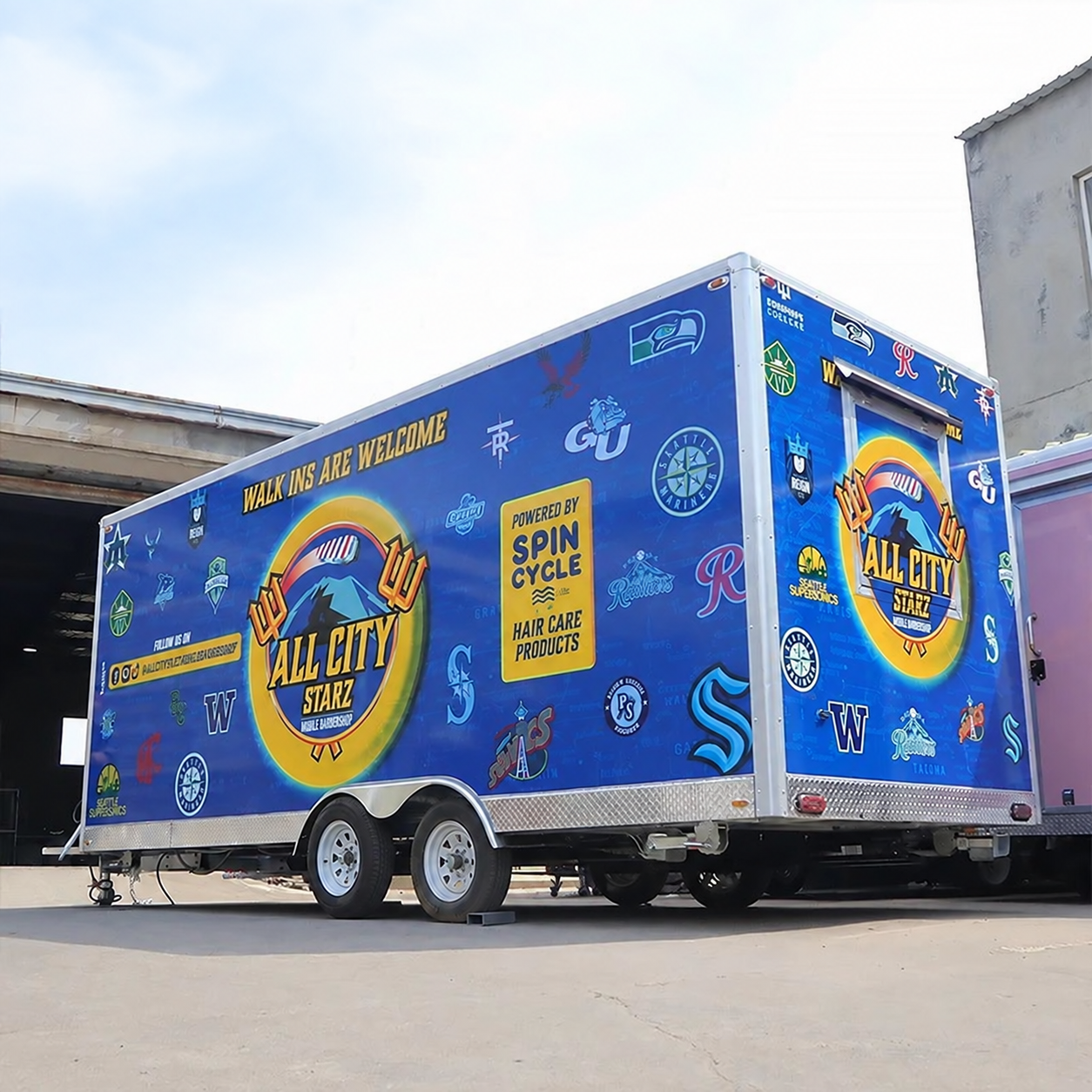 Blue wrapped business trailer — retouched supplied photograph